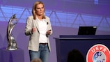 England manager Sarina Wiegman addresses the audience at the conference at St George's Park. The Women's EURO trophy she won for the second time in succession is alongside her.