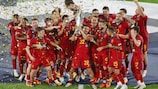 Spain celebrates with the trophy in 2023